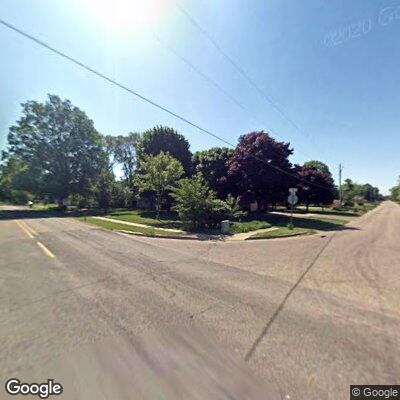 Brush fire reported approximately two feet from a home, with trees on fire