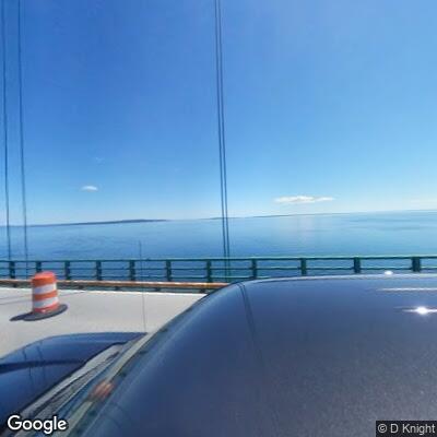 Two motorcycles driving dangerously on one lane of Mackinaw Bridge.