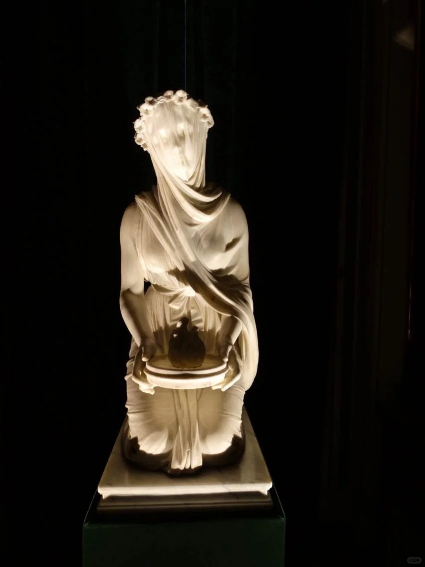 The veiled lady looks like she is in a dungeon.