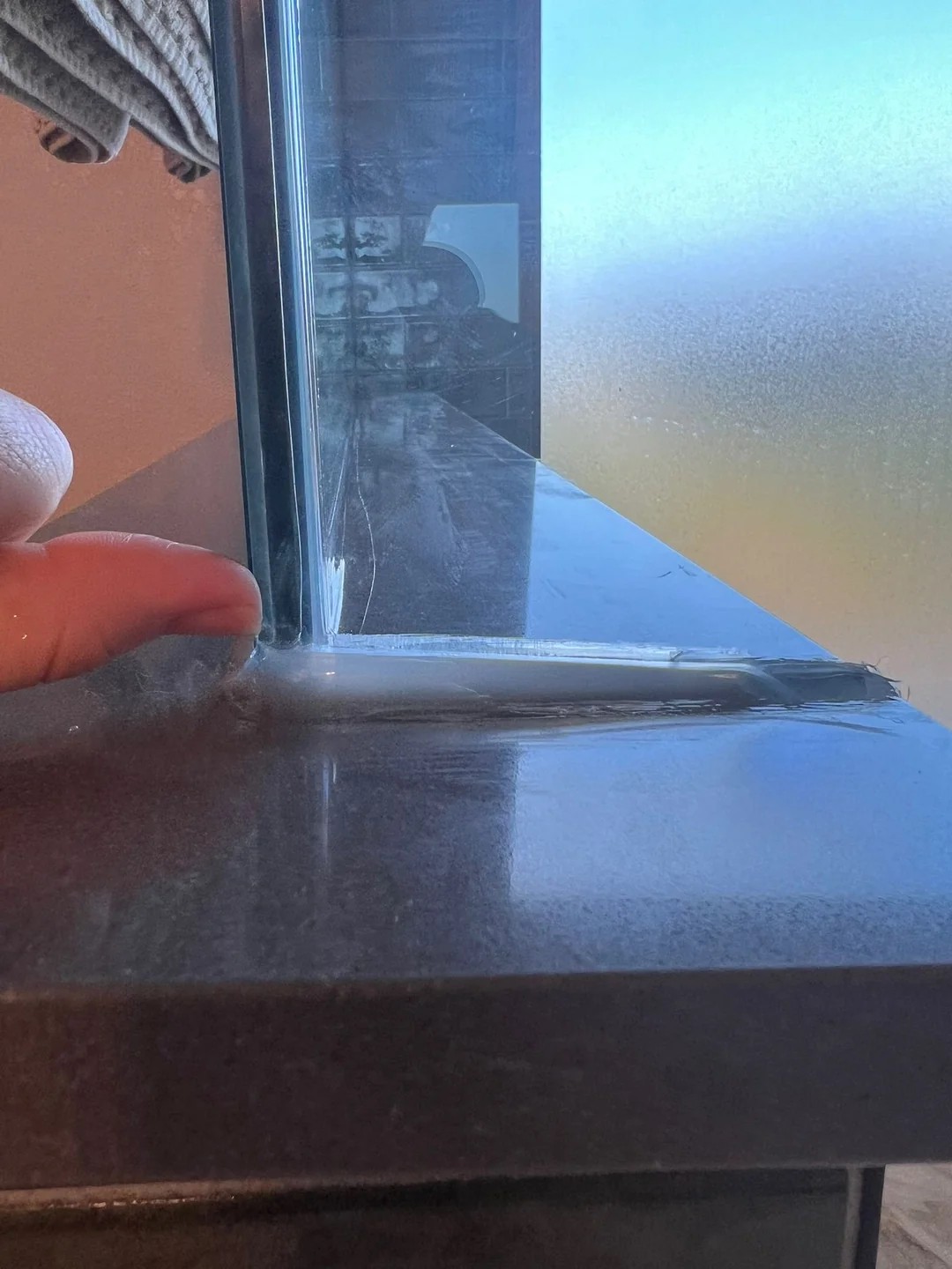 Is this normal? contractor cut a notch into our quartz shower ledge for glass install