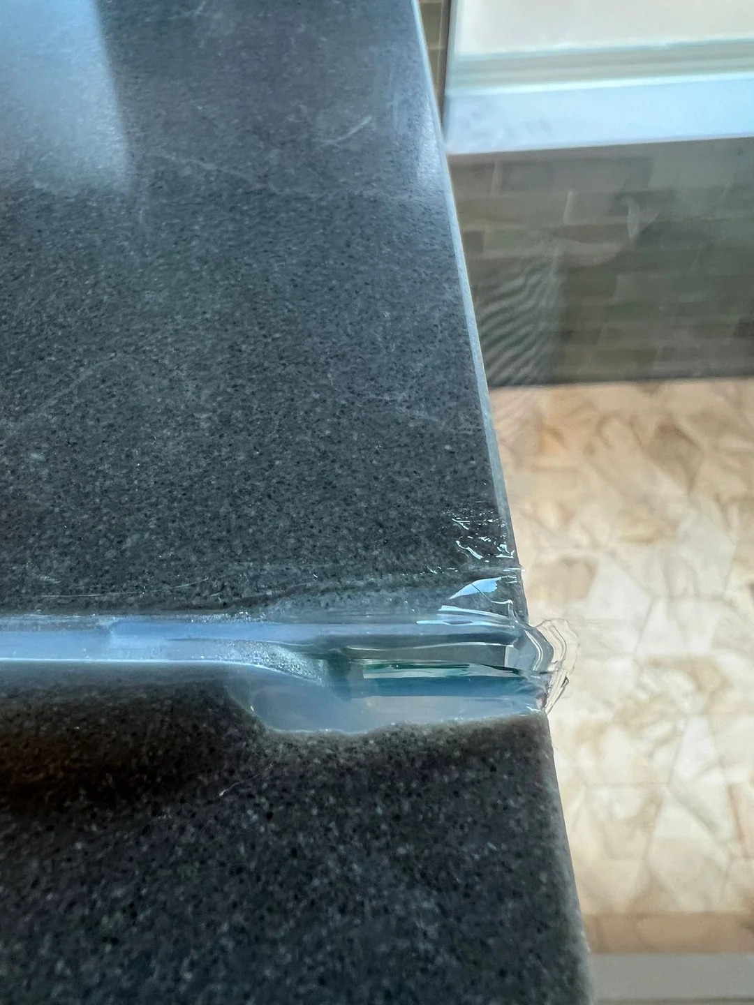 Is this normal? contractor cut a notch into our quartz shower ledge for glass install