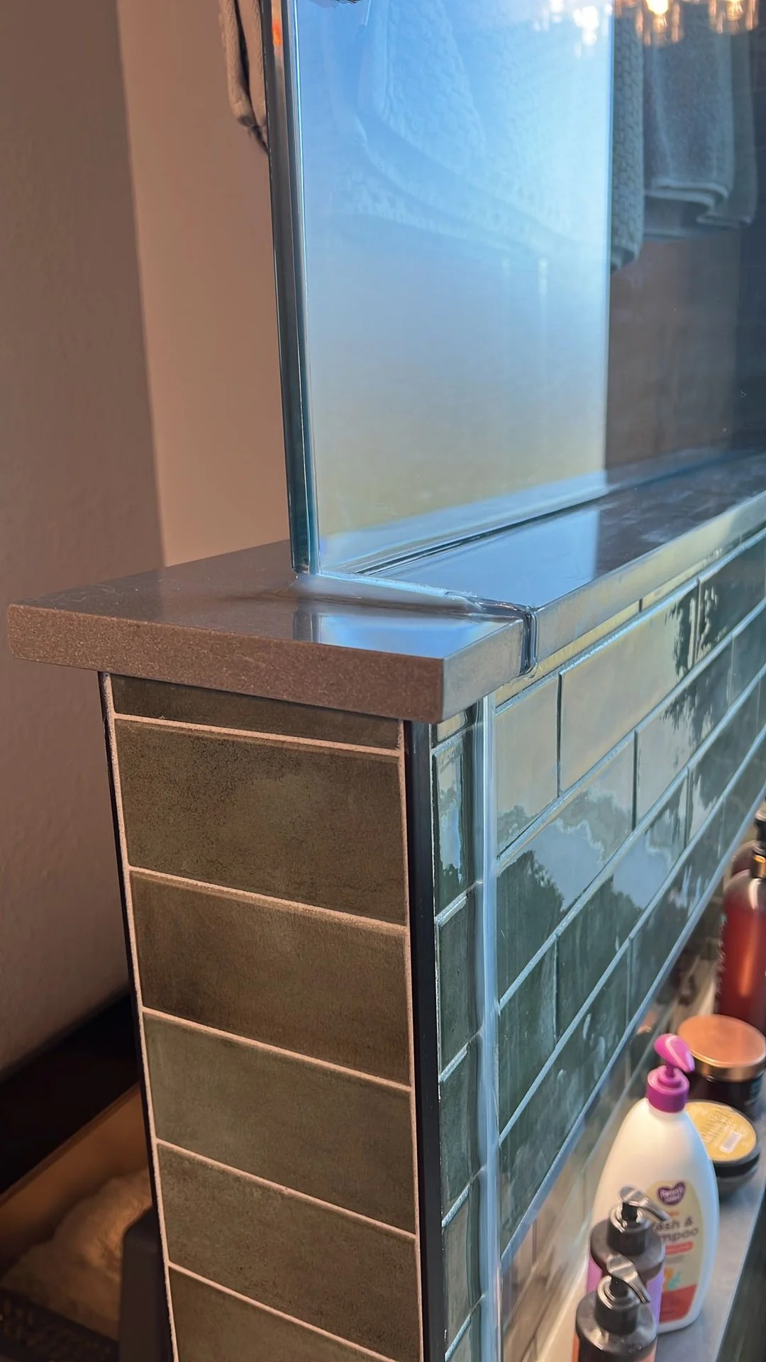 Is this normal? contractor cut a notch into our quartz shower ledge for glass install