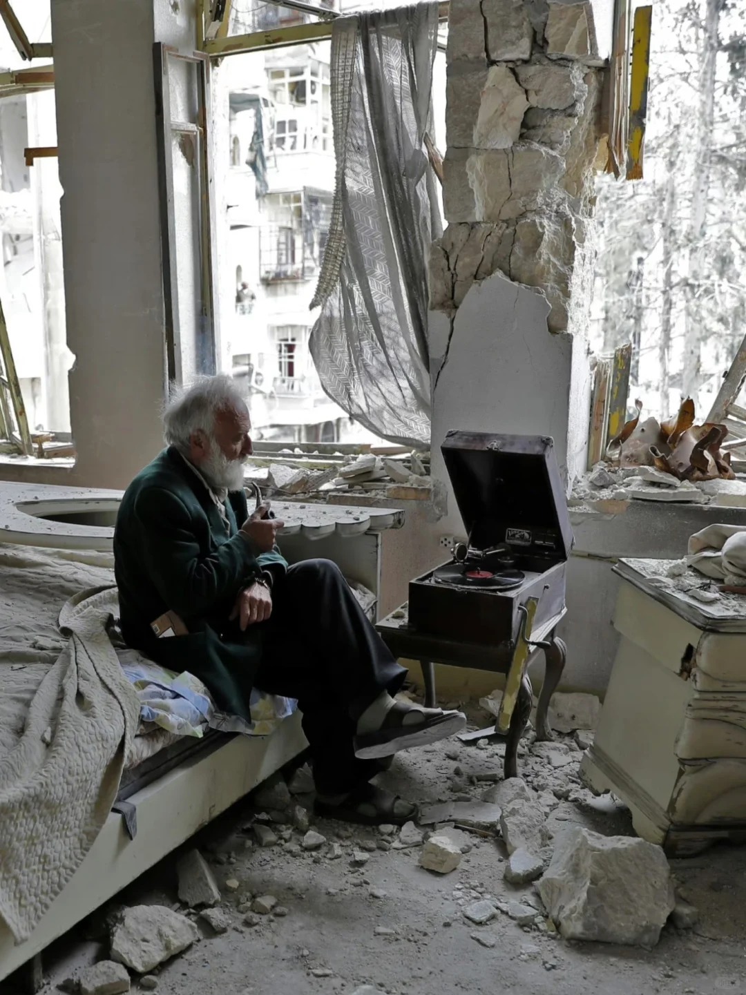 An old man listening to music amid the ruins