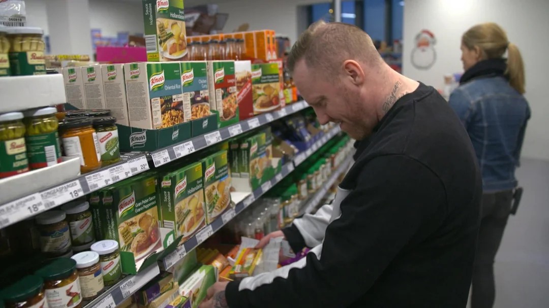An inmate browsing an aisle in a supermarket inside a maximum security prison in Denmark